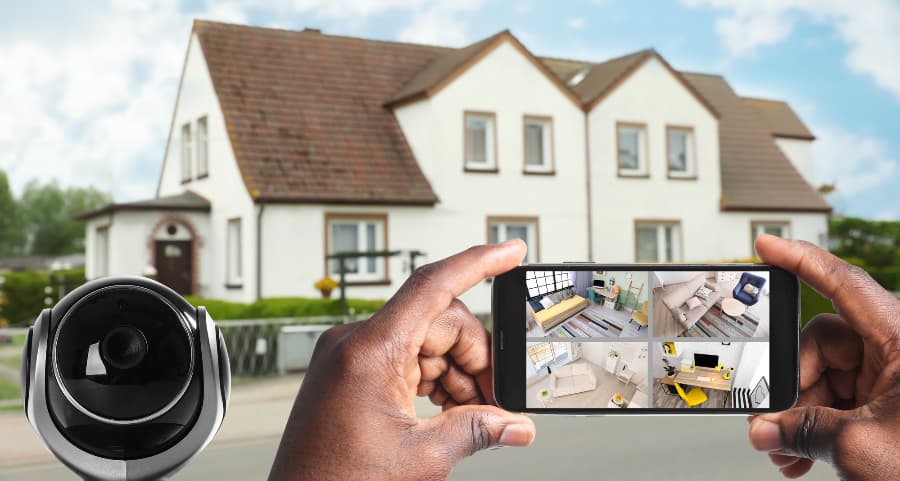 Man holding smartphone and checking streams from surveillance cameras
