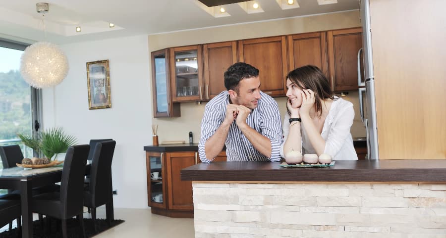Happy couple sharing a moment in a modern kitchen